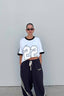 ssaint oversized white t shirt with black binding around neck and sleeve, two black stripes down sleeve but twenty two number on front in whitee with black edging worn on model tucked up 