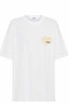 SSAINT white oversized T shirt with cream small heart in left hand corner with black ssaint writing in it front view 